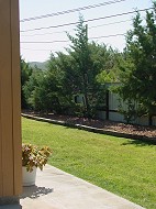 Patios overlook communal grassy area.